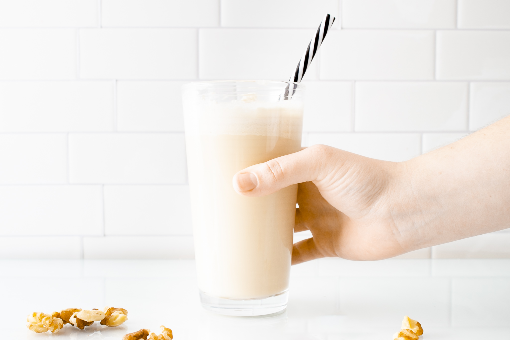 cold coffee with hand and black straw