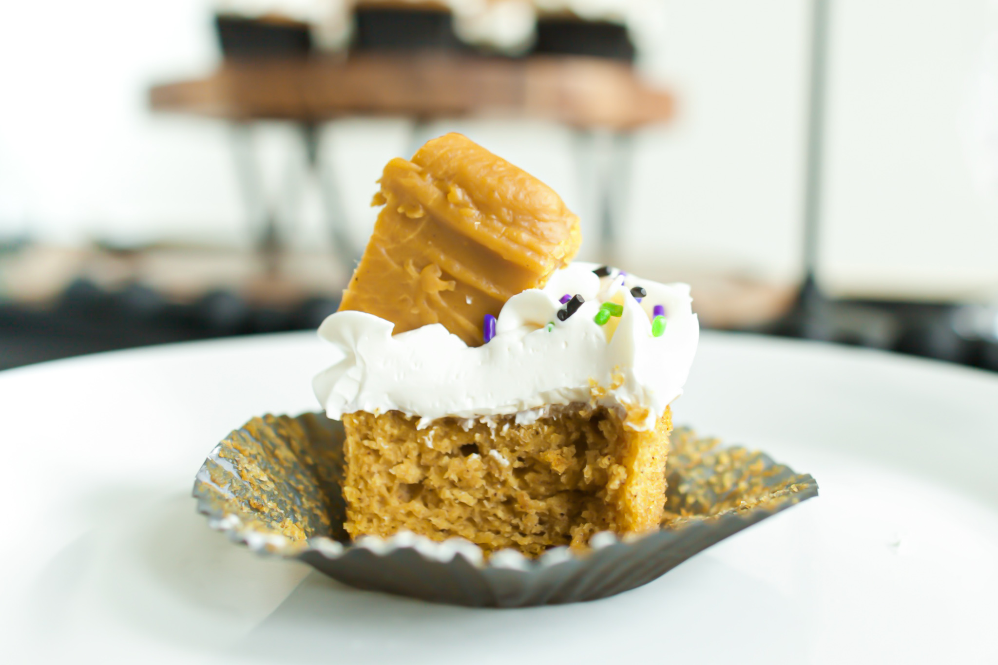 eaten pumpkin cupcake with cream cheese frosting and pumpkin fudge with sprinkles