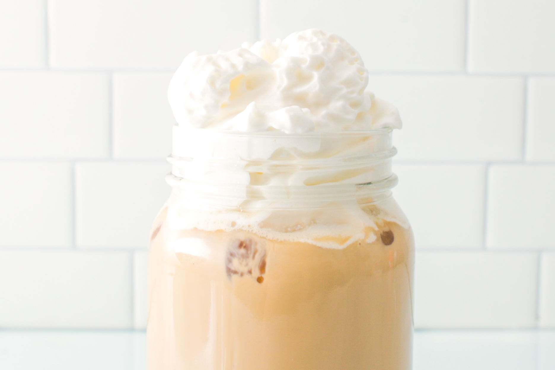 Mint Mocha Latte in glass cup with whipped cream and mint fudge